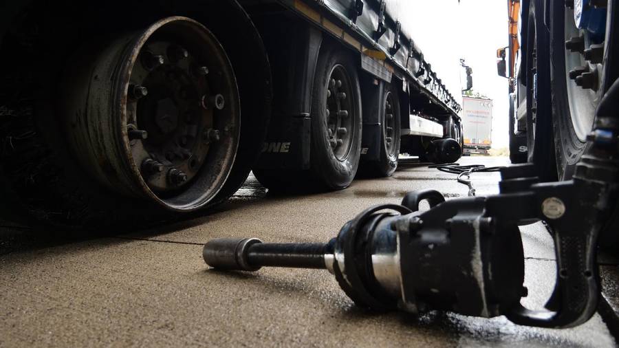 Tyre-fitting tool and a trailer wheel at a workshop